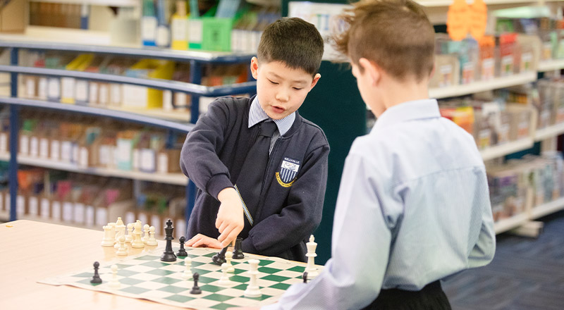 Students playing chess in the library in chess club at Our Lady of The Rosary Primary School Kellyville