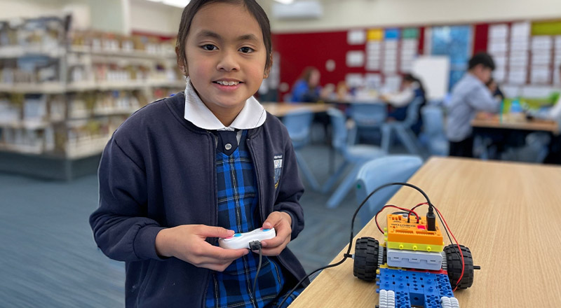 Student driving a robotic car she built in the classroom at Our Lady of The Rosary Primary School Kellyville