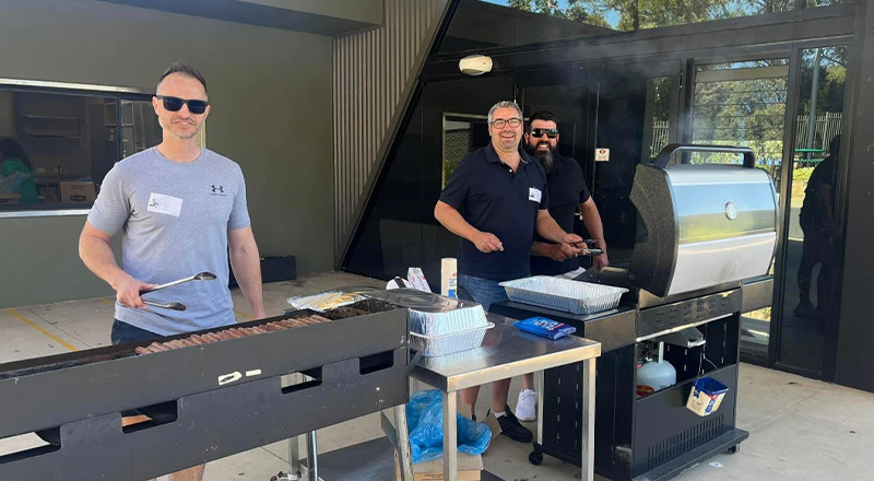 Fathers volunteering to cook a barbecue at a school event at Our Lady of The Rosary Primary School Kellyville
