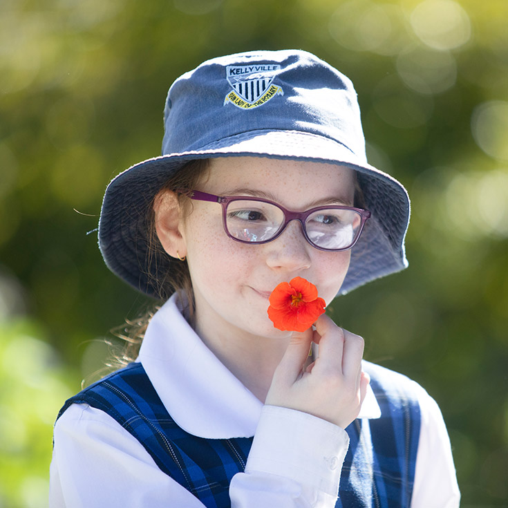 Student tasting the nectar from a flower at Our Lady of The Rosary Primary School Kellyville