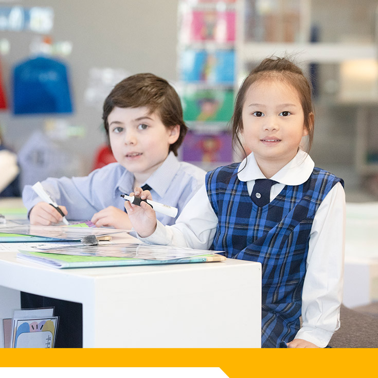 Students sitting together at their desk in the classroom at Our Lady of The Rosary Primary School Kellyville