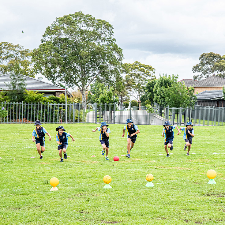 Students running on the school oval at Our Lady of The Rosary Primary School Kellyville