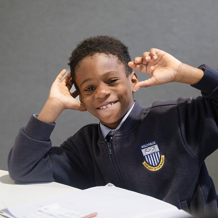 Student smiling at his desk at Our Lady of The Rosary Primary School Kellyville